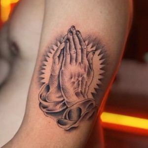 Praying hands tattoo by Isaiah
