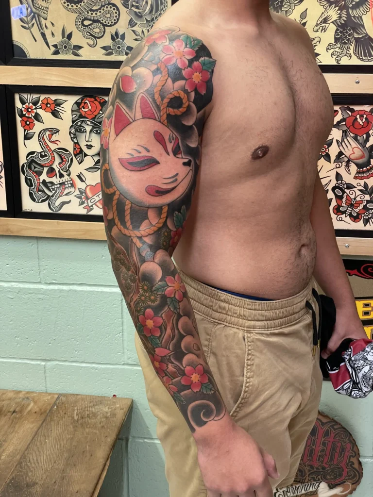 Full sleeve traditional tattoo by Kawika
