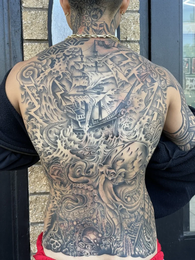 Traditional ocean scene back tattoo by Kawika.