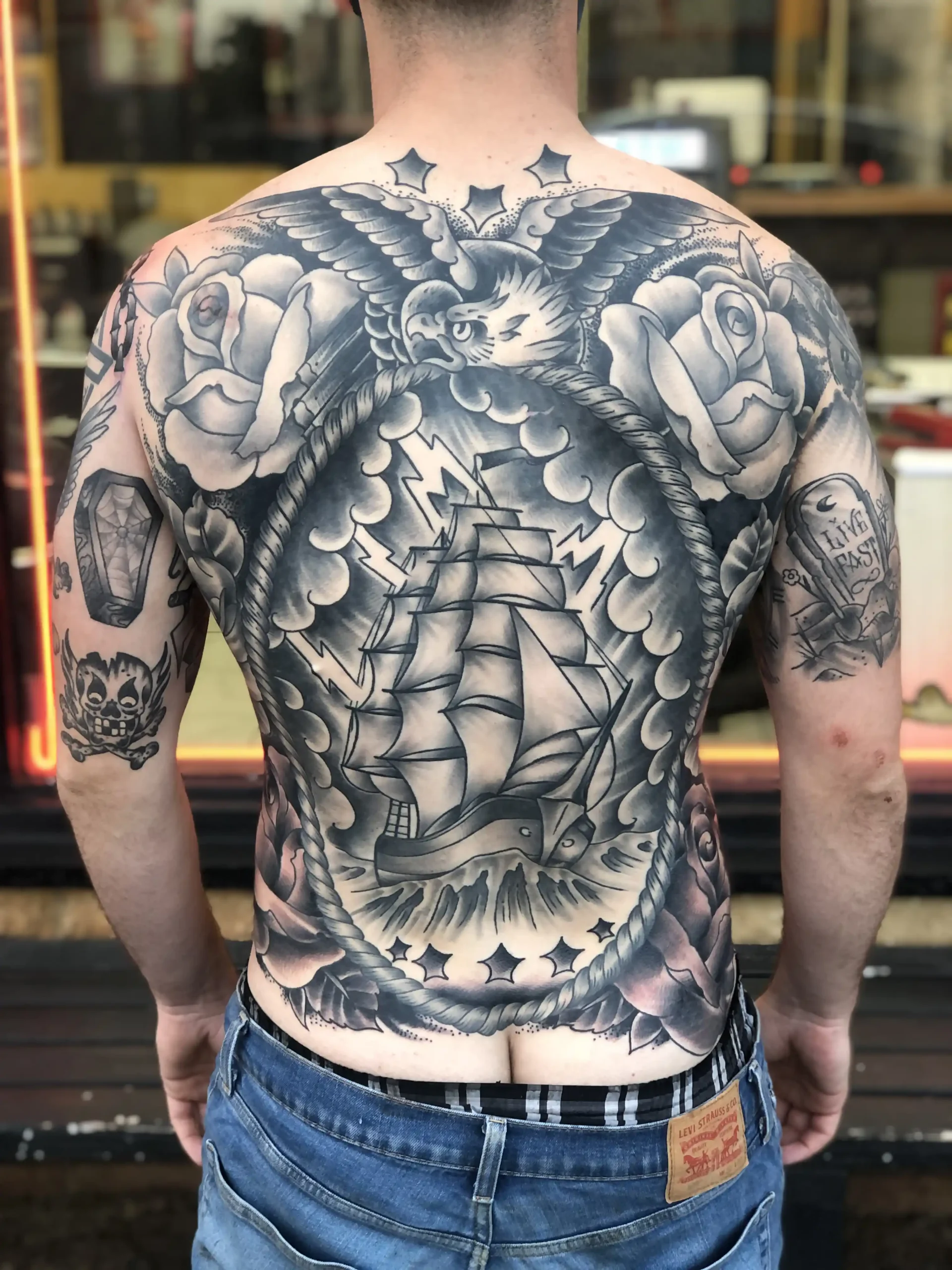 Full back black and grey pirate ship, eagle tattoo by Chris