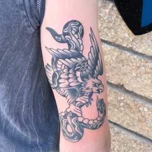 Eagle Clutching snake tattoo by Chris
