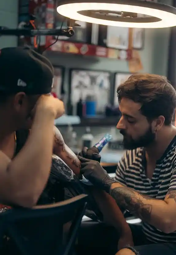 Damian giving a tattoo