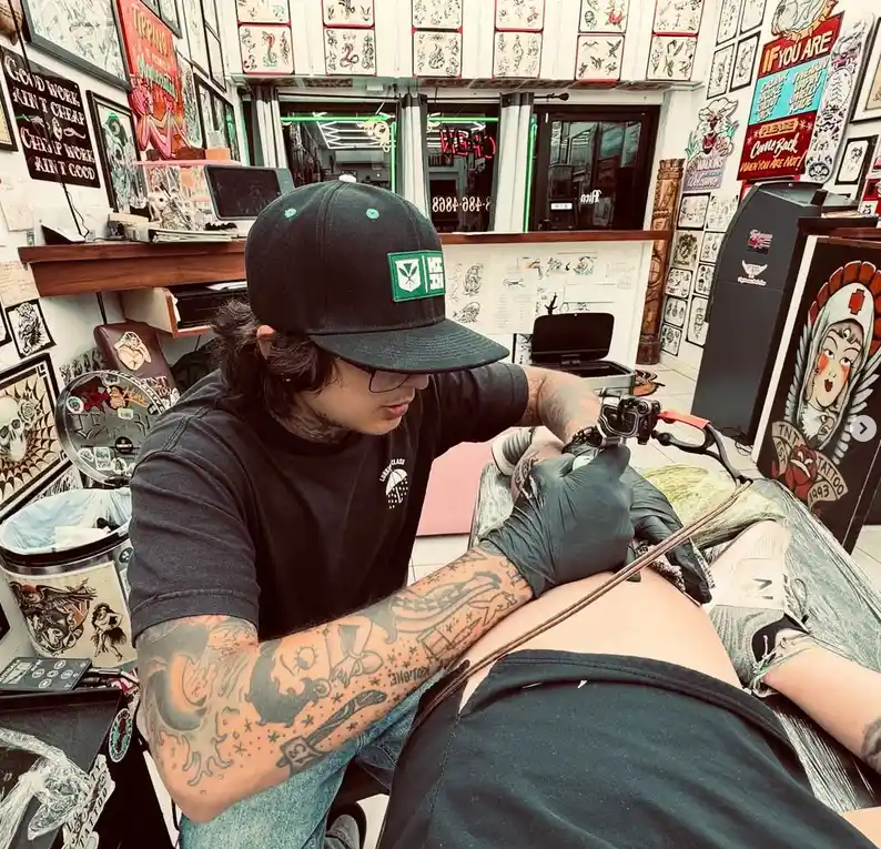 Myles giving a tattoo