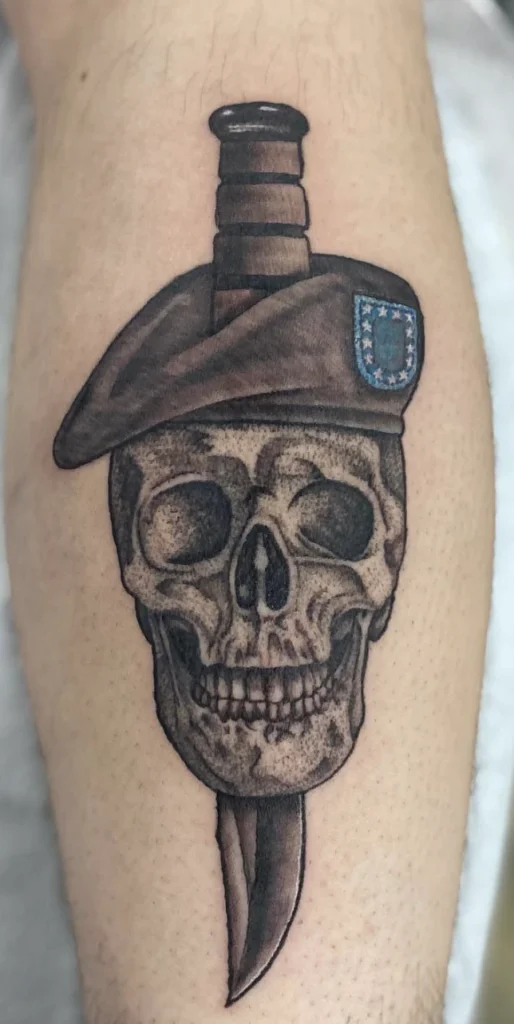 Skull and knife tattoo